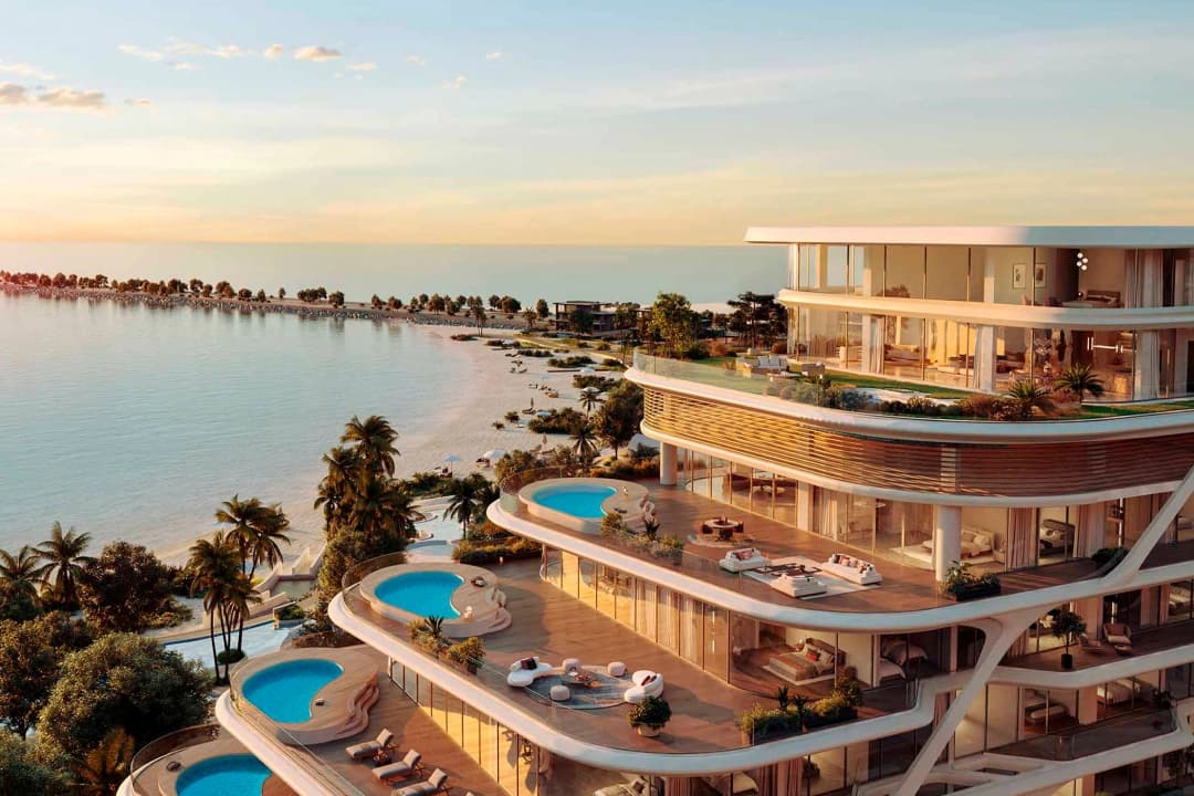Luxury waterfront villa with pools, ocean views, and palm trees