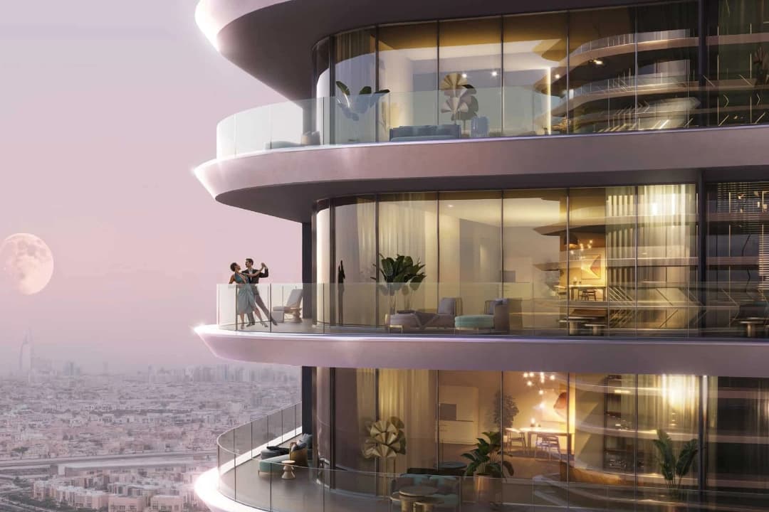 Couple enjoying the view from a high-rise balcony at night