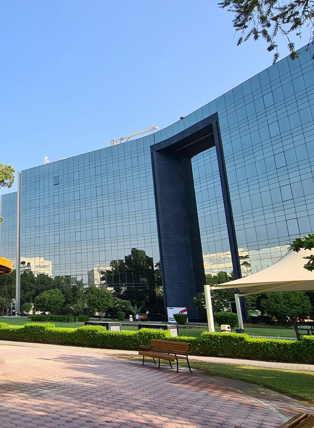 Sleek office building with glass windows reflecting the sky