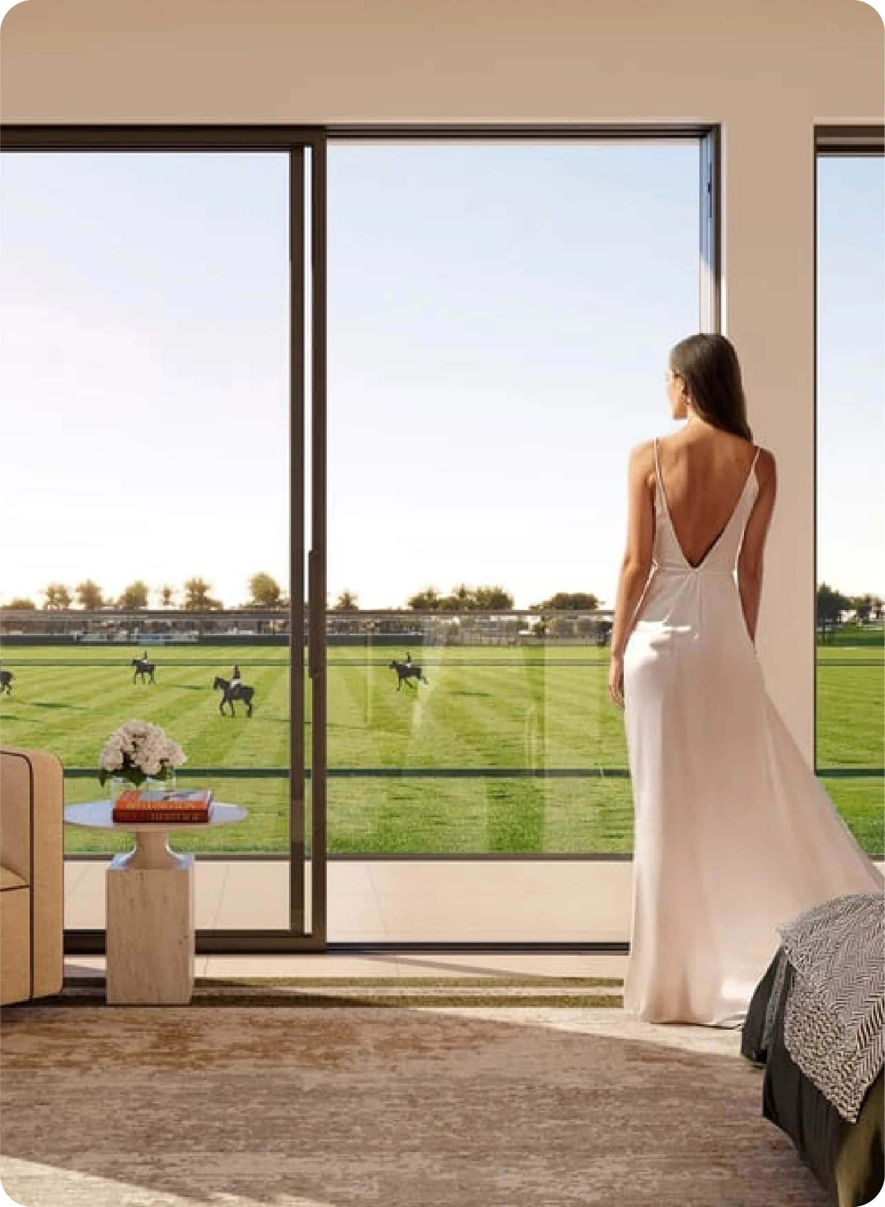 Infinity pool overlooks a polo field with riders