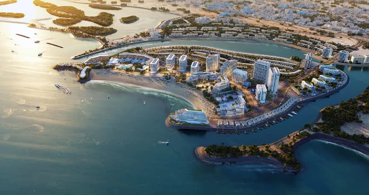 Aerial view of a coastal resort with luxury buildings and yachts
