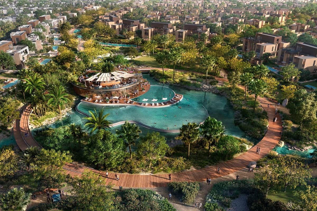 Luxurious resort with pool and lush greenery.