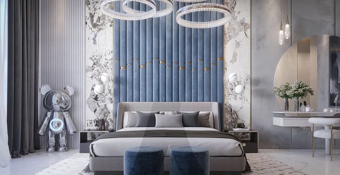 Stylish bedroom with blue headboard and chandeliers